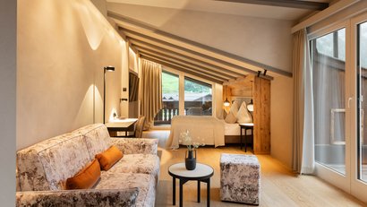 Modern cozy room with sofa, bed, and balcony in natural tones